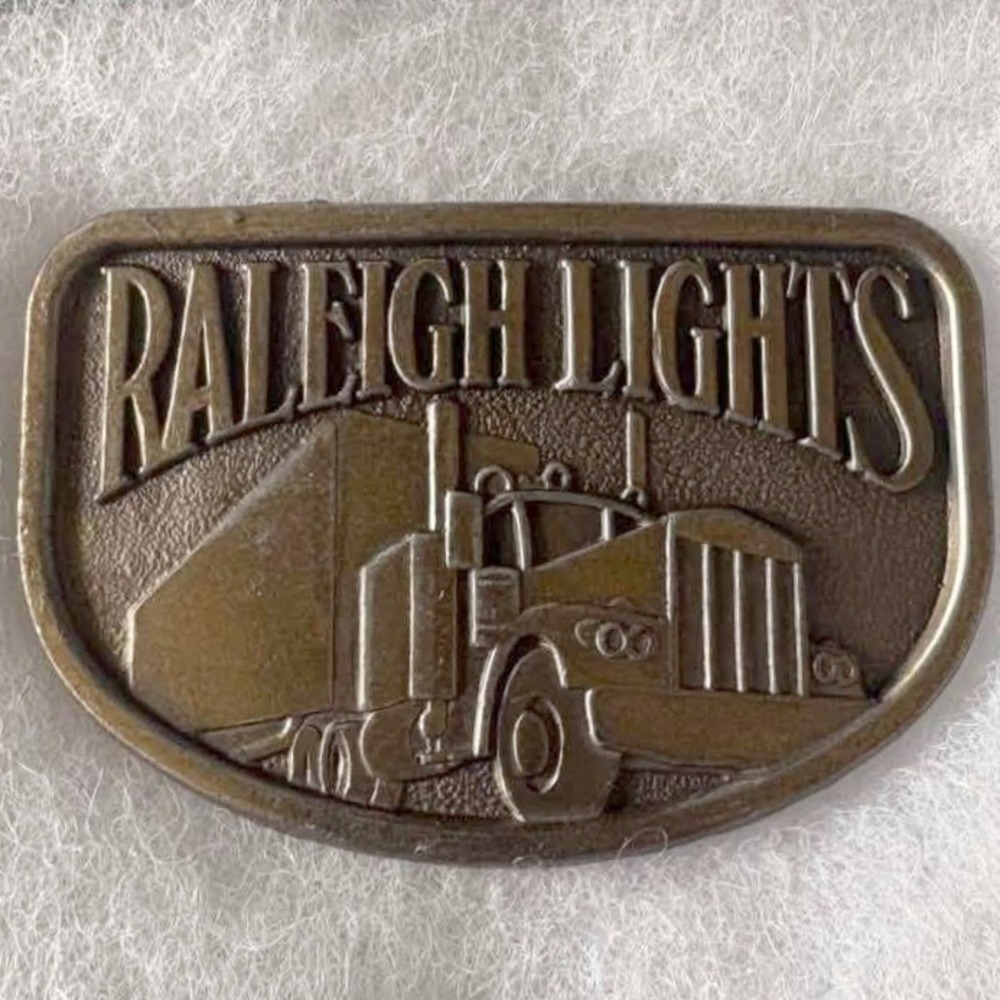 Vintage Raleigh Lights Semi Truck Belt Buckle Brass Tone Tobacco Promo 3.25in